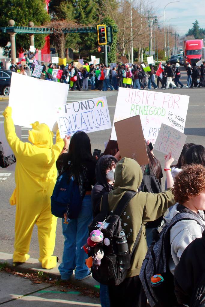 Students hold signs asking for their schools to be funded and for justice for Renee Good and Alex Pretti during a demonstration that culminated at Pacific Way S. and S. 320th St. Renee Good and Alex Pretti were killed in Minnesota by ICE officers. Photo by Keelin Everly-Lang / the Mirror