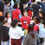 Students play clapping games and participate in other activities to build a sense of belonging at No One Eats Alone Day.