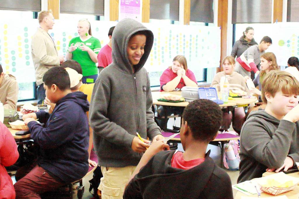Students complete bingo sheets to learn more about each other at the No One Eats Alone lunchtime activity at Illahee Middle School. Photo by Keelin Everly-Lang / the Mirror