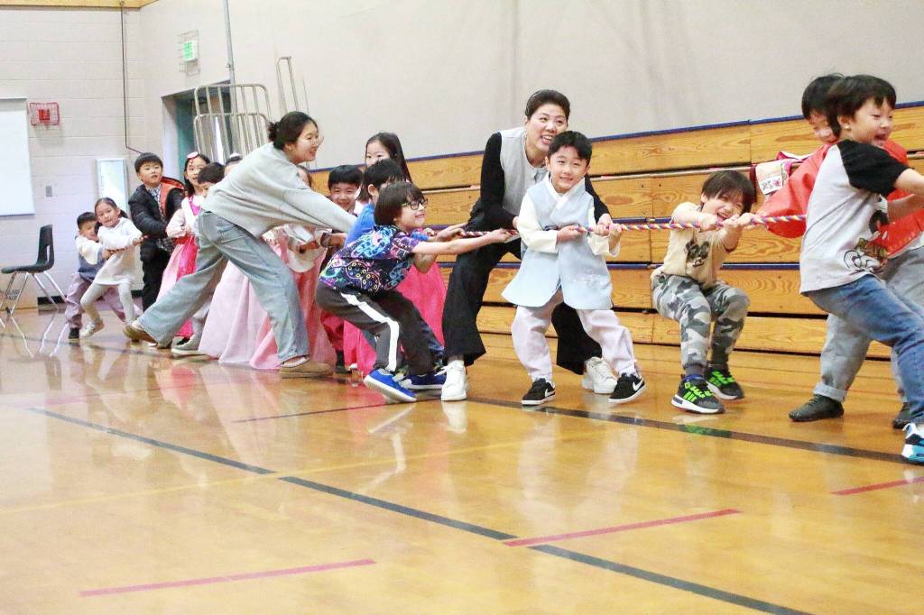 Parents join in to help young students compete in a tug-of-war game. Photo by Keelin Everly-Lang / the Mirror
