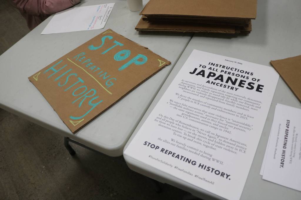 A sign created by a community member rests next to an updated version of Executive Order 9066 from Tsuru for Solidarity, this time calling for descendants and survivors to stand up against state violence against immigratn communities. Photo by Bailey Jo Josie/Sound Publishing