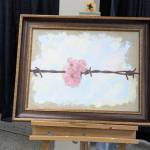 Cherry blossoms and barbed wire express a reflection on Japanese incarceration in this painting by Chris Hopkins. Photo by Bailey Jo Josie/Sound Publishing