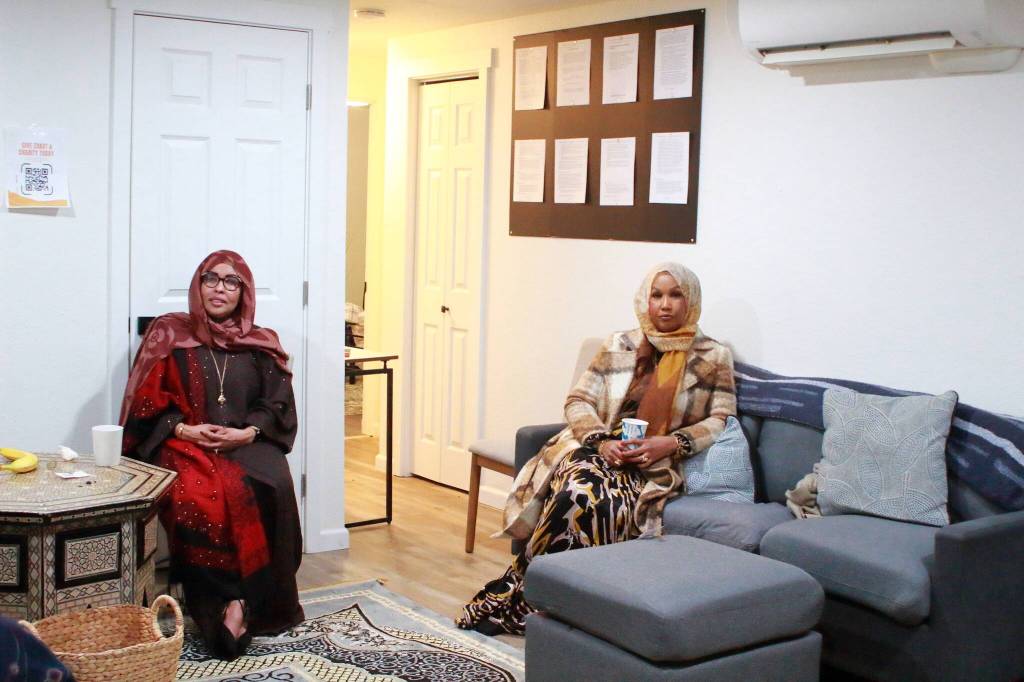 Guests celebrating the opening of the House of Du'a gather in the living room of the new faith-centered culturally responsive housing for women. Photo by Keelin Everly-Lang / the Mirror