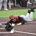 Myles Myers dives into home for the Thomas Jefferson Raiders. Ben Ray / The Reporter