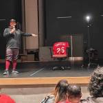 Harold Adams points at Joe Townsends jersey during his speech to players and families. Ben Ray / The Reporter