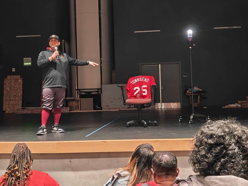 Harold Adams points at Joe Townsends jersey during his speech to players and families. Ben Ray / The Reporter