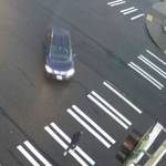 A woman crosses the street right before being hit by the dark car on Feb. 26, 2024, at the intersection of 19th Avenue SW and SW Campus Drive. Photo from SafeCity footage
