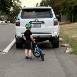 A child stands behind a car parked illegally in the protected shoulder on 26th Avenue SW, an area that is intended to be reserved for pedestrians and other modes of travel, like bikes. Photo courtesy of Mike Bollich Ziegler