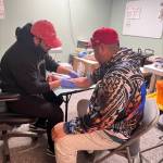A representative from King County Public Health performs a free TB test at the PICA-WA wellness fair event on March 26 in Federal Way.