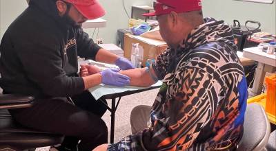 A representative from King County Public Health performs a free TB test at the PICA-WA wellness fair event on March 26 in Federal Way.