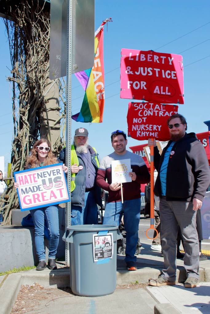 Caroline Vadino, Tim Burns, Federal Way City Council member Martin Moore and Nathan Orth with a food donation collection bin at the Federal Way No Kings protest on March 28. Photo by Keelin Everly-Lang / the Mirror