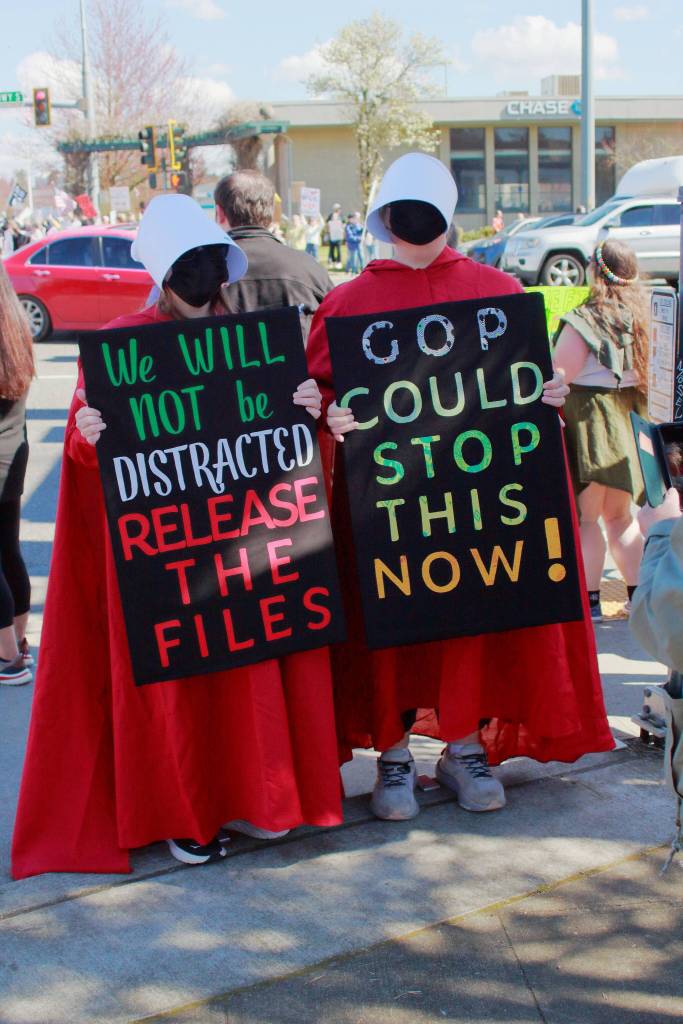 Two protesters wore references to book and TV series The Handmaids Tale and made statements calling for the release of the Epstein files at the Federal Way No Kings protest. Photo by Keelin Everly-Lang / the Mirror