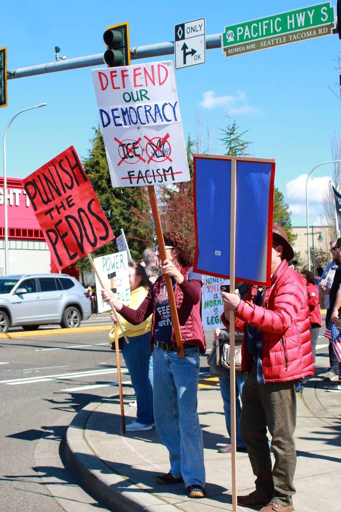 A sign makes a reference to the lack of arrests related to the Epstein files in the U.S. along with a call to defend U.S. democracy at the No Kings protest in Federal Way on March 28. Photo by Keelin Everly-Lang / the Mirror