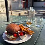 Hollywood Taverns burger, sweet potato fries and whiskey on the patio. Photo by Mindy Stern