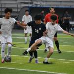 Joseph Rodriguez-Corona fends off two Decatur players. Ben Ray / The Reporter