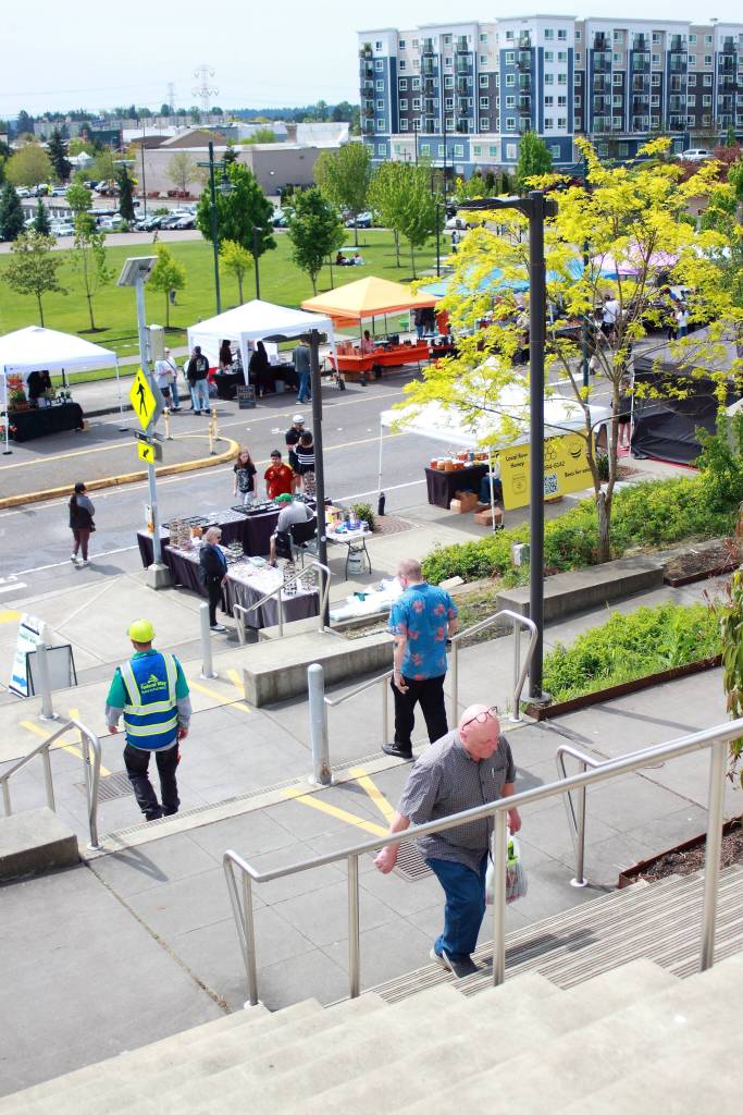 Federal Way community members travel between the two levels of the Federal Way Farmers Market on opening day. Photo by Keelin Everly-Lang / the Mirror