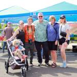 Federal Way city parks staff and family members enjoy the opening day of the Federal Way Farmers Market. Photo by Keelin Everly-Lang / the Mirror