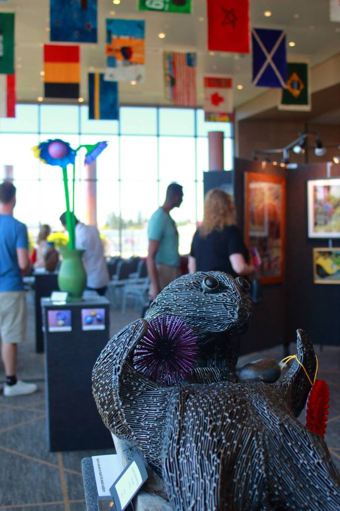 Flags designed by local youth hung from the ceiling above sculptures, paintings and much more at the annual arts explosion. This otter was created by a Federal Way artist. Photo by Keelin Everly-Lang / the Mirror.