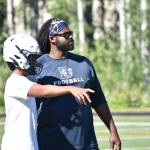 Evan Cook talks with a Decatur player during practice. Ben Ray / The Mirror