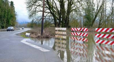 Flood waters approach State Route 203 at the northern intersection of Neal Road SE, March 20, 2026. Some county funds for 2026-2027 will be disappropriated and will be used for a roads project to support flood recovery projects. (Grace Gorenflo/Valley Record)