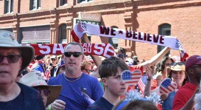 Fans hoist scarves as the march to Seattle Stadium continued. Ben Ray / The Reporter